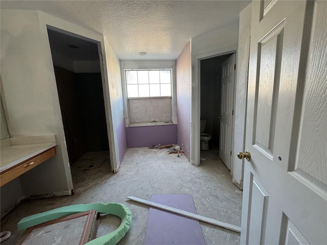 bathroom with a textured ceiling and toilet