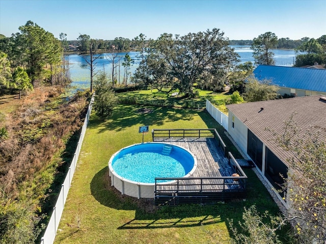 view of pool featuring a deck with water view and a yard