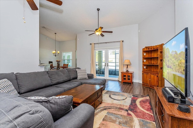 living room with lofted ceiling, a textured ceiling, french doors, and dark wood-type flooring