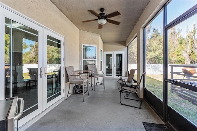 sunroom / solarium with ceiling fan and french doors