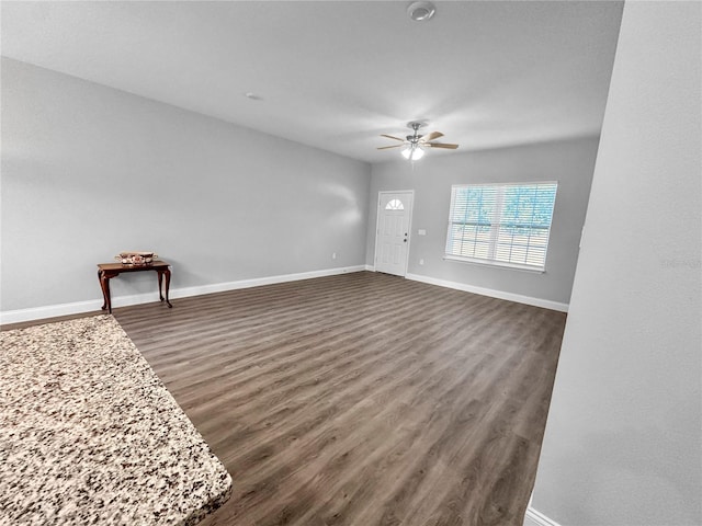 unfurnished living room with ceiling fan and dark hardwood / wood-style flooring