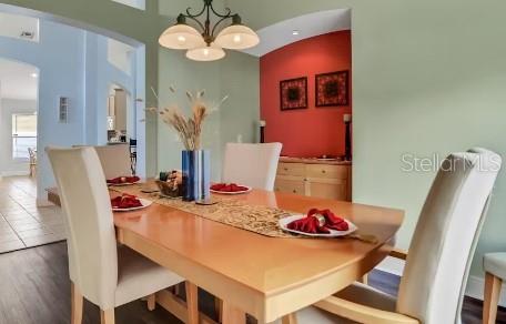 dining room featuring dark hardwood / wood-style flooring and a chandelier