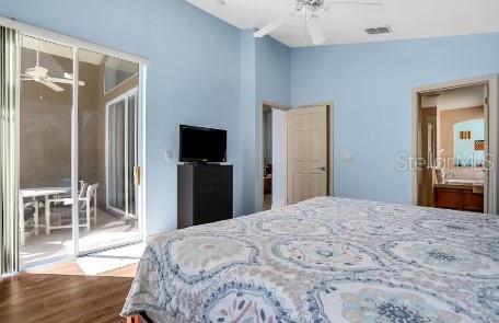 bedroom with hardwood / wood-style floors, ceiling fan, lofted ceiling, and a closet