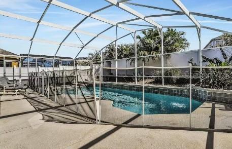 view of pool featuring a lanai and a patio