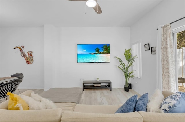 living room featuring wood-type flooring and ceiling fan