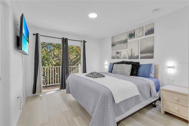 bedroom featuring access to exterior and light hardwood / wood-style floors