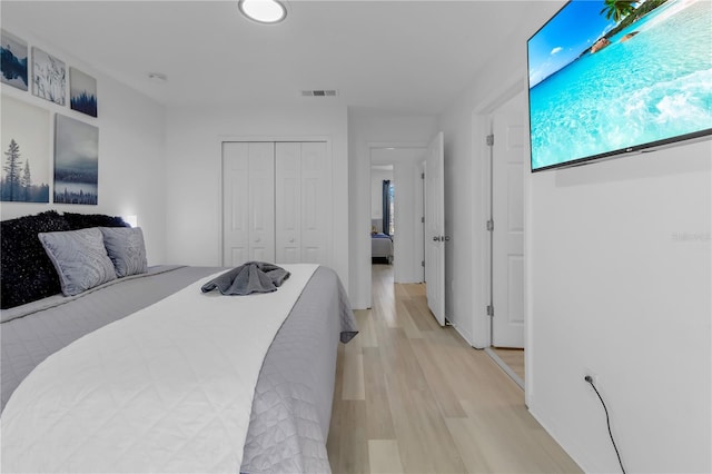 bedroom with a closet and light wood-type flooring