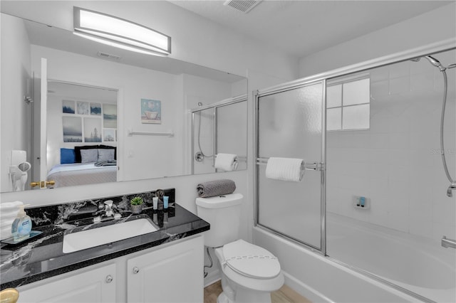 full bathroom featuring vanity, toilet, and enclosed tub / shower combo