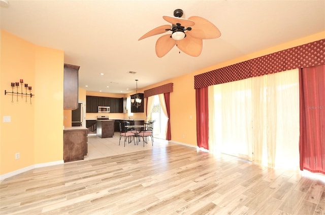 living room featuring light wood-type flooring and ceiling fan