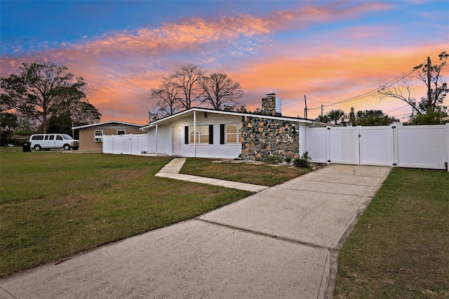 ranch-style home with a lawn