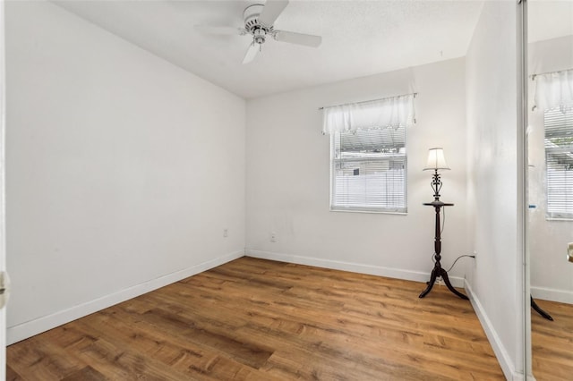 unfurnished room featuring ceiling fan and wood-type flooring