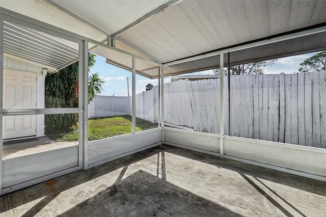 unfurnished sunroom with lofted ceiling