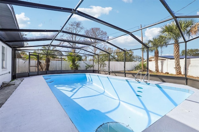 view of pool with glass enclosure