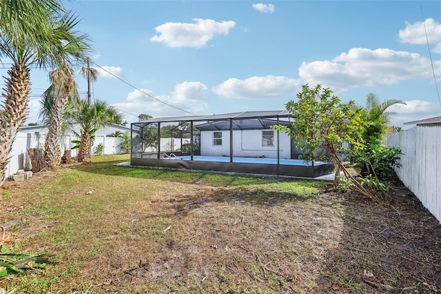 view of yard featuring glass enclosure