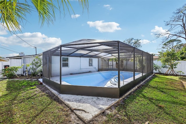 view of pool with a lanai and a yard