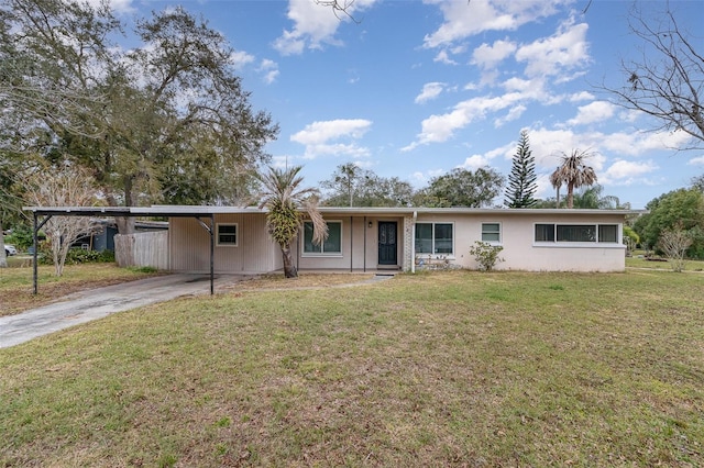 ranch-style house featuring a carport and a front lawn