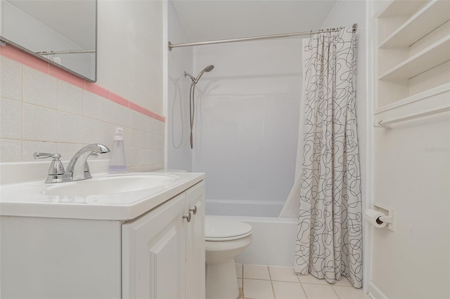 full bathroom with tile patterned floors, toilet, shower / bath combo with shower curtain, vanity, and tile walls