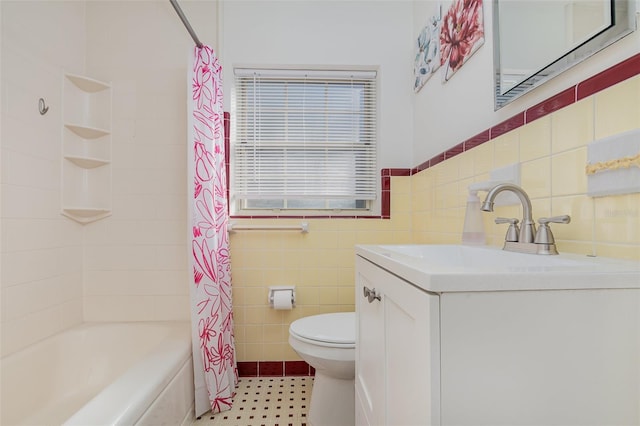 full bathroom featuring vanity, toilet, tile walls, and shower / bath combo with shower curtain