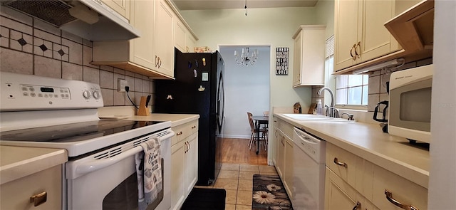 kitchen with backsplash, white appliances, extractor fan, sink, and light tile patterned flooring