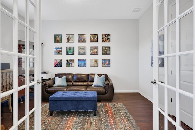 sitting room with french doors and dark wood-type flooring