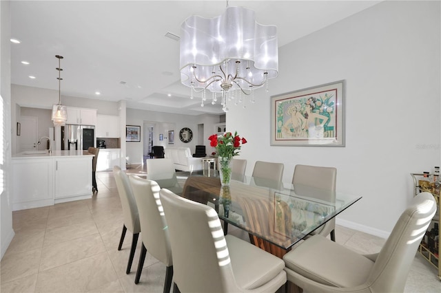 tiled dining room featuring sink and a chandelier