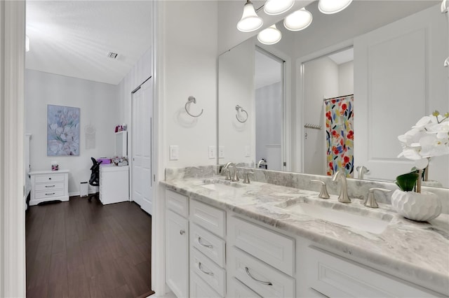 bathroom featuring wood-type flooring and vanity