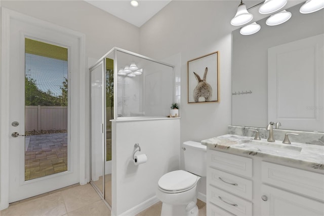 bathroom with toilet, vanity, tile patterned floors, and a shower with door