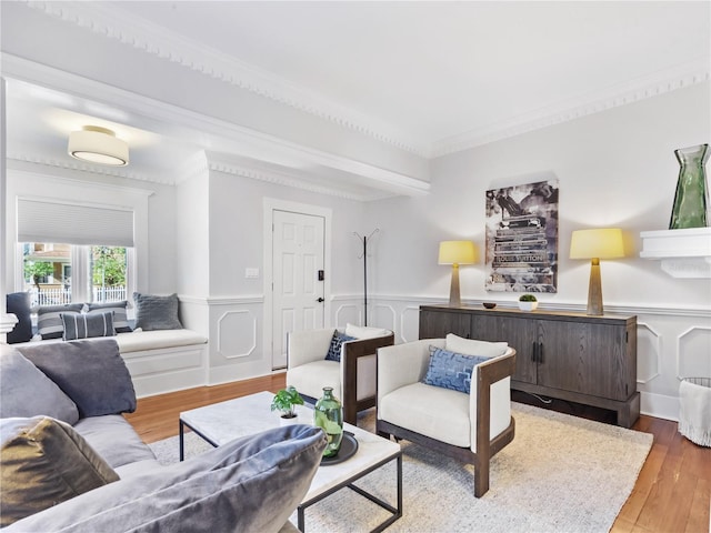 living room with hardwood / wood-style floors and crown molding