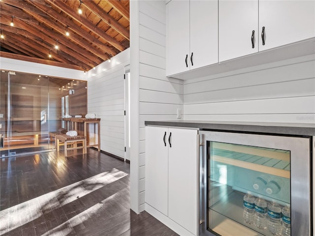 details featuring wooden ceiling, beamed ceiling, hardwood / wood-style floors, wine cooler, and wood walls