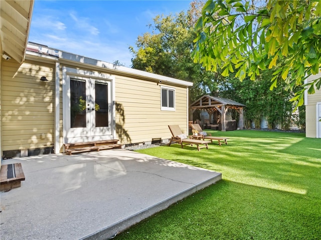 back of property featuring a gazebo, a patio area, and a lawn