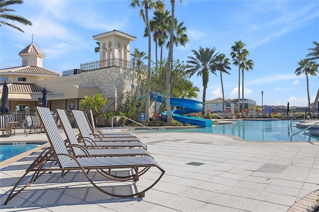 view of swimming pool featuring a patio and a water slide