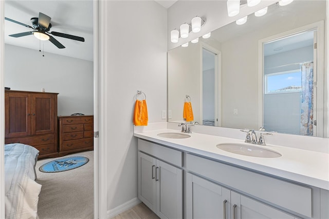 bathroom with walk in shower, vanity, and ceiling fan