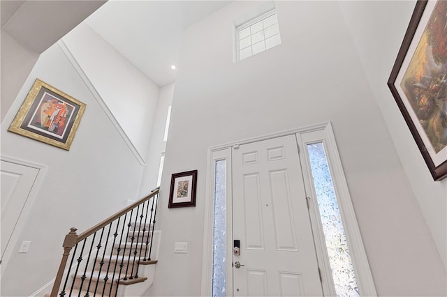 foyer featuring a towering ceiling