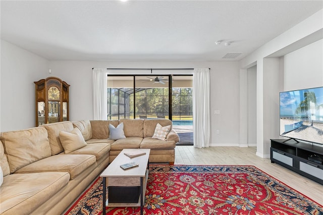 living room featuring ceiling fan and light hardwood / wood-style floors