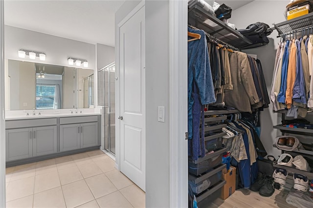 bathroom featuring tile patterned floors, vanity, and walk in shower