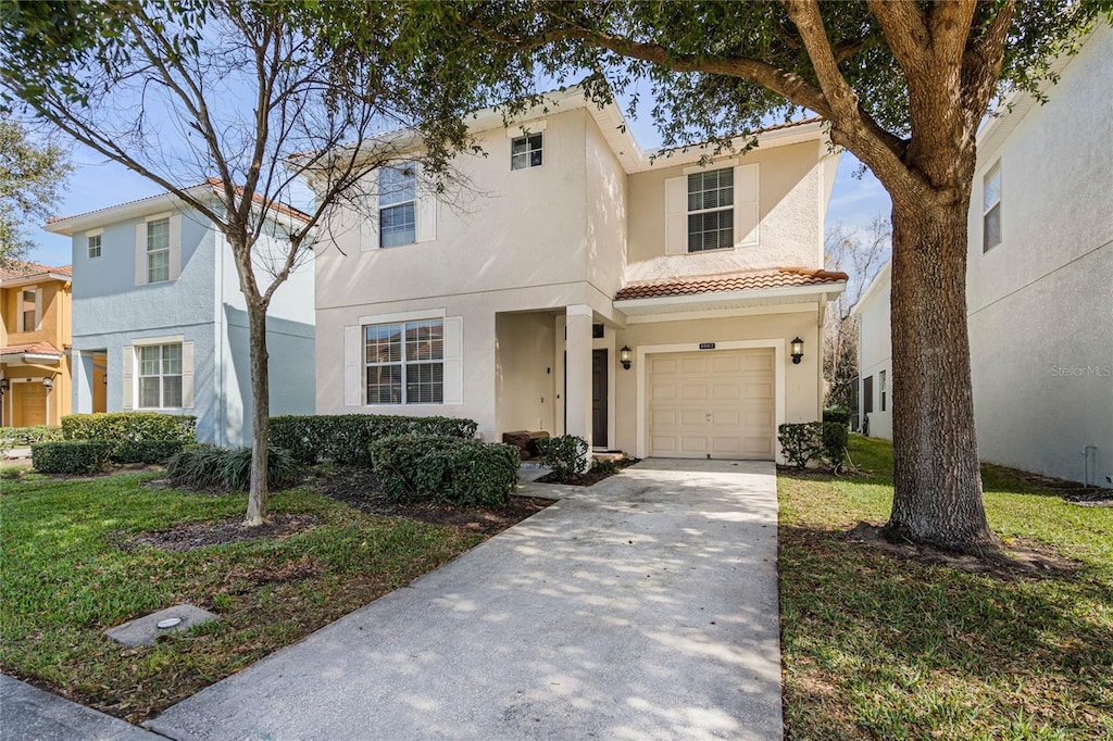 view of front facade featuring a garage and a front lawn