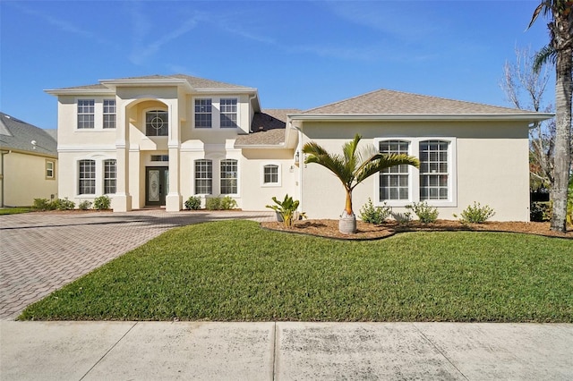 mediterranean / spanish-style house featuring a front yard