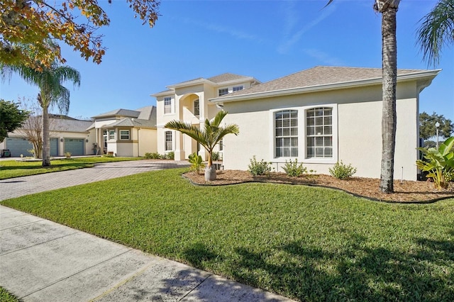 mediterranean / spanish-style house with a garage and a front yard