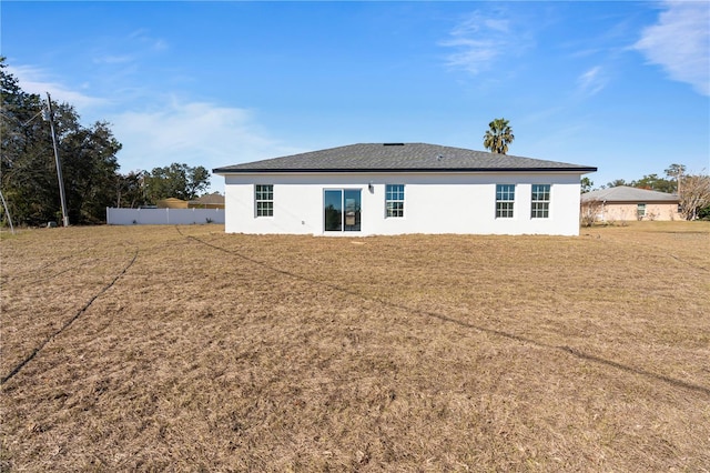 back of house featuring a yard