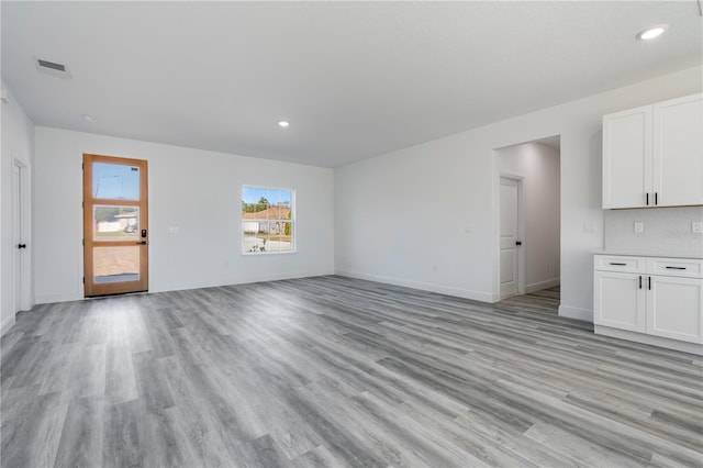 unfurnished living room featuring light wood-type flooring