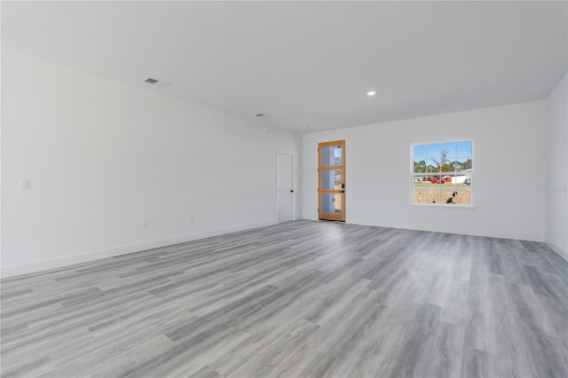 empty room with light hardwood / wood-style floors