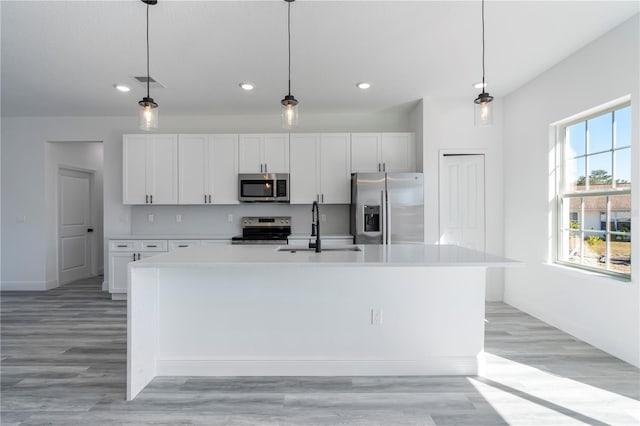 kitchen with white cabinetry, sink, an island with sink, and appliances with stainless steel finishes