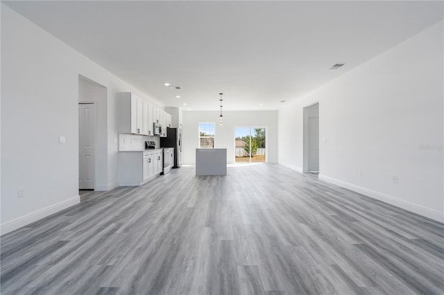 unfurnished living room with light hardwood / wood-style flooring