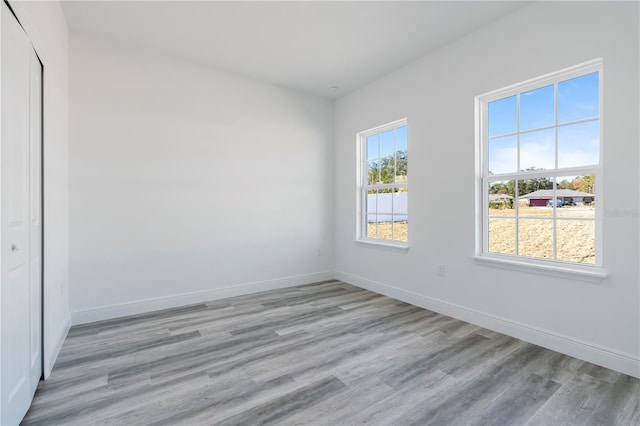 unfurnished room with light hardwood / wood-style floors