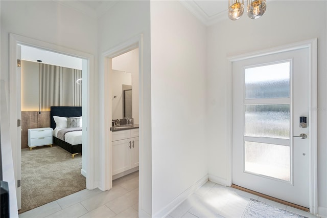 interior space with light colored carpet, an inviting chandelier, ornamental molding, and sink