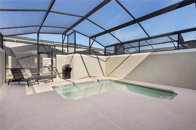 view of pool with a patio area and a lanai