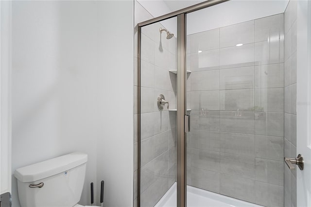 bathroom featuring an enclosed shower and toilet