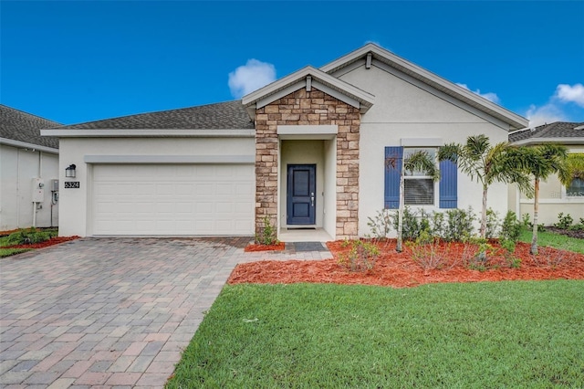 ranch-style home featuring a front lawn and a garage