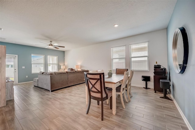 dining room with ceiling fan and a textured ceiling