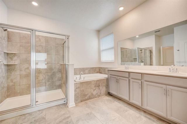 bathroom with tile patterned flooring, shower with separate bathtub, and vanity